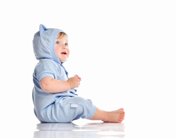 Baby wearing funny blue suit sit on studio floor — Stock Photo, Image