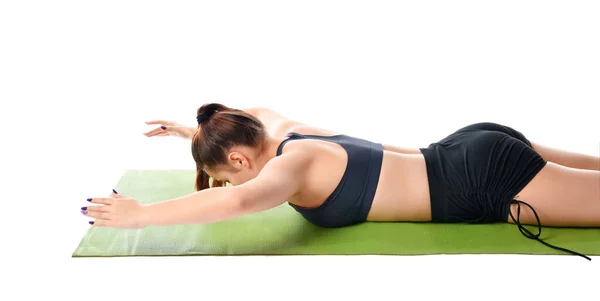 Close up of a woman lying on her stomach on a sports mat and doing exercise. — Stock Photo, Image