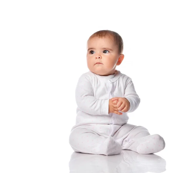 Portrait of a concerned child sitting in the studio on a white background. — Stock Photo, Image