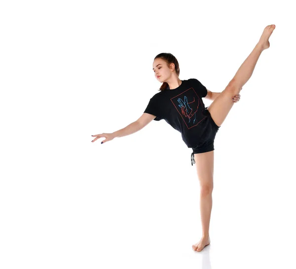 Flexible chica deportiva realiza elementos de baile sobre un fondo blanco en el estudio. — Foto de Stock