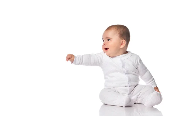 Little baby reaching hand aside sitting on floor — Stock Photo, Image