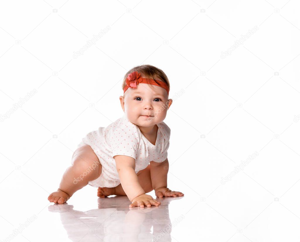 little baby girl laughing, creeping playing in the studio, isolated on white background