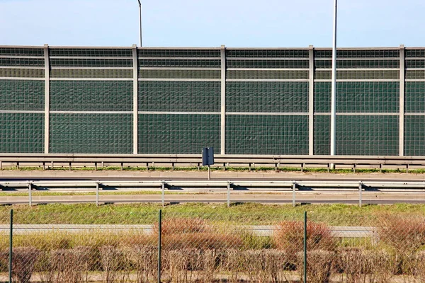 protective fence by the road. noise and dirt insulation from the roadway. environmental protection and public safety.