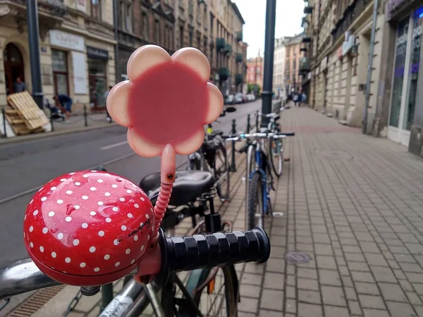 the bike in the city after the rain, the bell and the mirror in the shape of a flower. Old town in the background, healthy lifestyle, moving without pollution. transport decorations