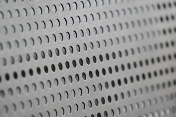 Perforated iron or metal surface, texture. Metal plate with many — Stock Photo, Image