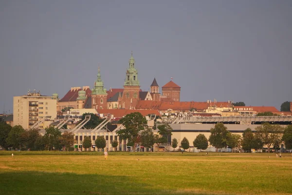 Kraków, Polska-08.01.2019: stare miasto w zachodzie słońca, miękkie żółte światło nad domami i polem. zbliża się burza, zaciemnione niebo, w oczekiwaniu na zjawisko naturalne — Zdjęcie stockowe