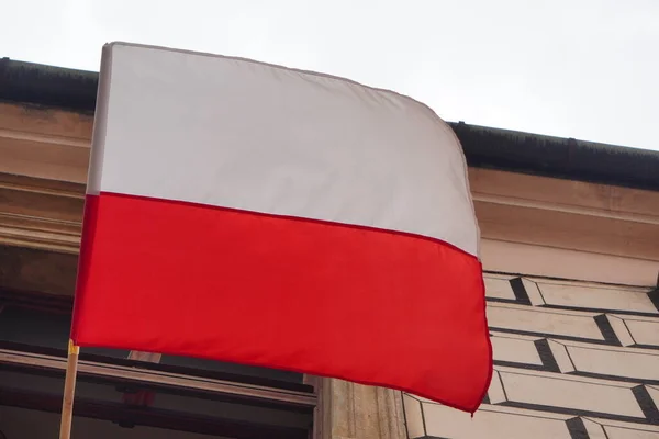 Polish white-red flag in wind on wall of the block or house. Natural Light Selective Focus. building view. 1 of May,November 11,flag or independence or labor day. Government holiday, President voting