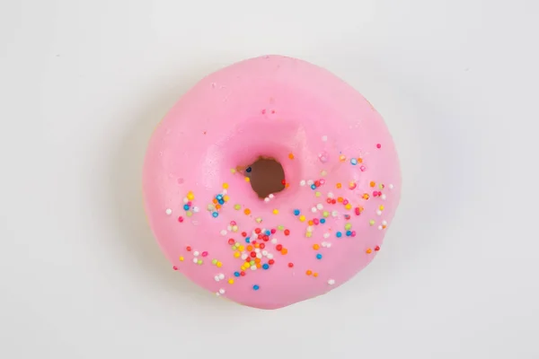 Ring doughnut fresh from the bakery with sprinkle sweets and icing on top
