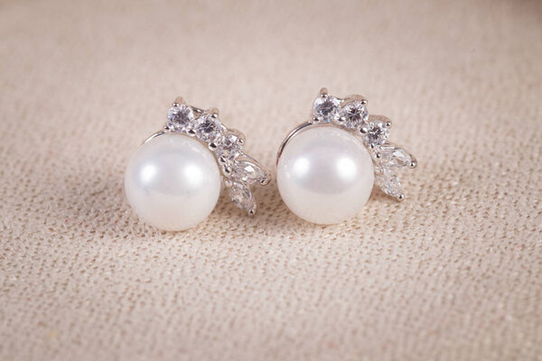 Silver earrings with diamonds macro shot.