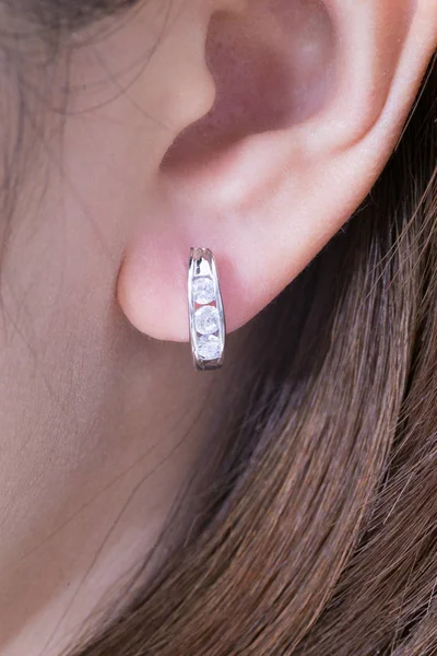 Silver earrings with diamonds macro shot.