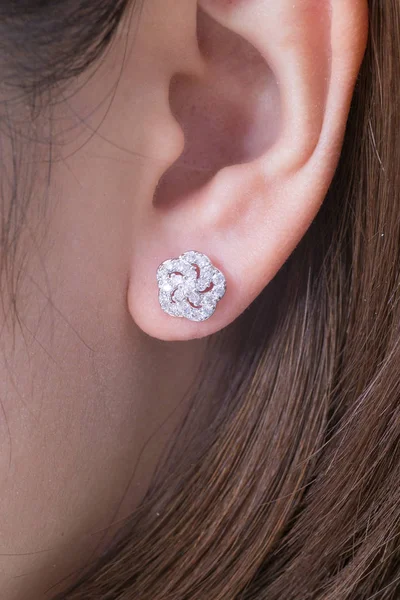 Silver earrings with diamonds macro shot.