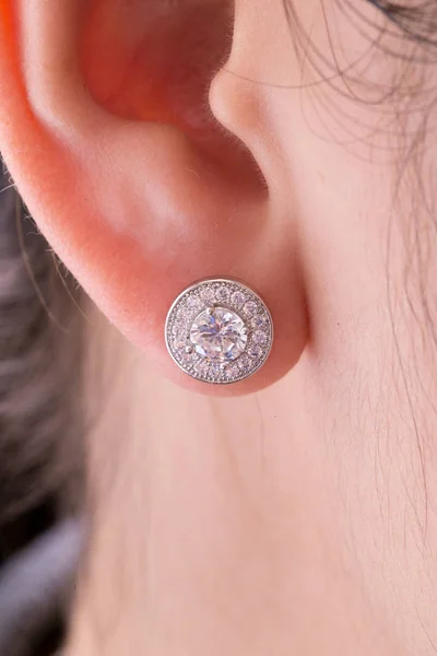 Silver earrings with diamonds macro shot.