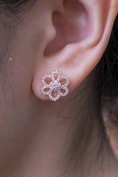 Silver earrings with diamonds macro shot.