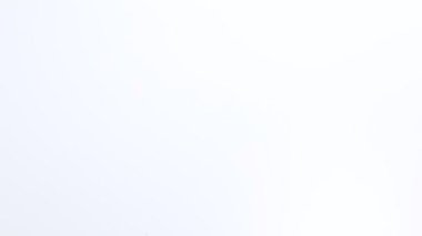 Kağıt raptiyeler beyaz masaya düşer. Okul malzemeleri. ataçlar kapanıyor.