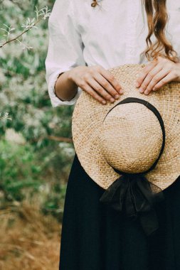 Kahverengi şapka elinde