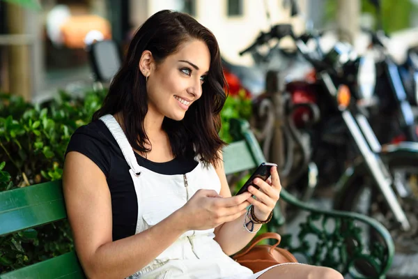 Uśmiechający Się Młoda Kobieta Patrząc Inteligentnego Telefonu Zewnątrz Dziewczyna Ubrana — Zdjęcie stockowe