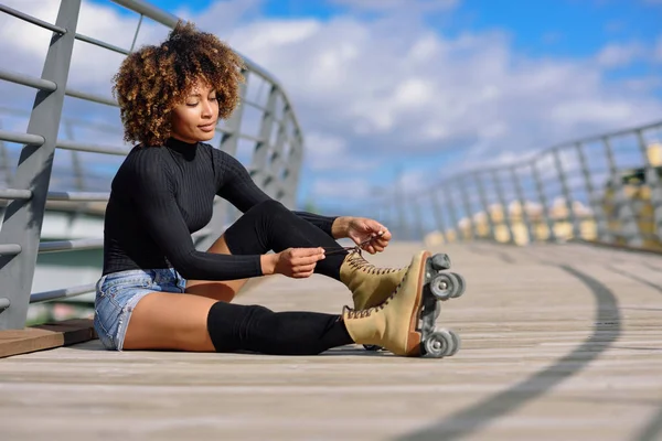 Joven Chica Negra Sonriente Sentada Puente Urbano Pone Patines Mujer —  Fotos de Stock