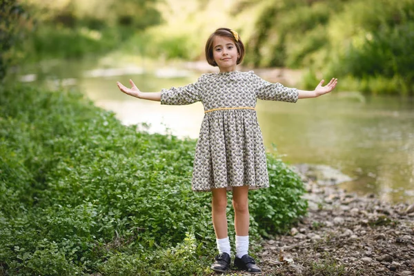 Little girl in nature stream wearing beautiful dress — Stock Photo, Image