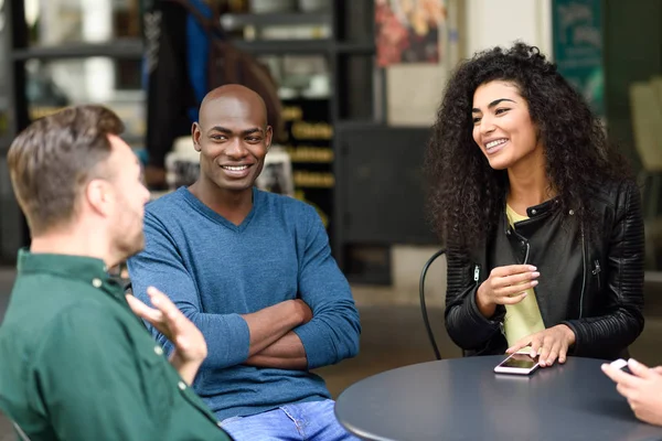 Multiracial group of friends waiting for a coffee together — Stock Photo, Image