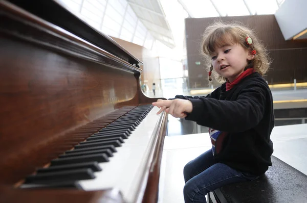 Little girl having fun playing the piano — Stock Photo, Image