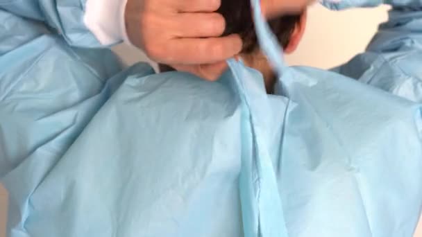 Female Doctor putting on her protective uniform — Stock Video