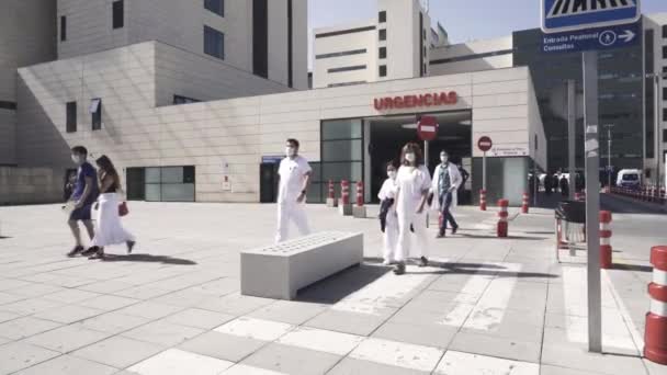 Zdravotničtí pracovníci nosí masky v blízkosti vaší nemocnice v důsledku pandemie Covid-19. — Stock video