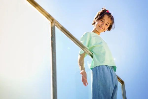 Niña de 9 años posando felizmente en una escalera — Foto de Stock