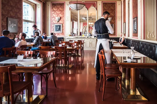 Prag, Çek Cumhuriyeti - 12 Temmuz 2020: Masalarda Garson ve Konukların oturduğu Cafe Louvre Interior. Geleneksel bir Grand Cafe Kafe ve Restoran..