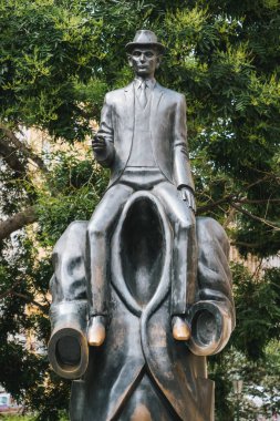 Prague, Czech Republic -  - July 11 2020: Statue of Franz Kafka Riding a Headless Figure by Jaroslav Rona near the Spanish Synagogue. clipart