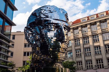 Prague, Czech Republc - July 11 2020: Turning Head of Franz Kafka in Czech Hlava Franze Kafky Statue by Davd Cerny clipart