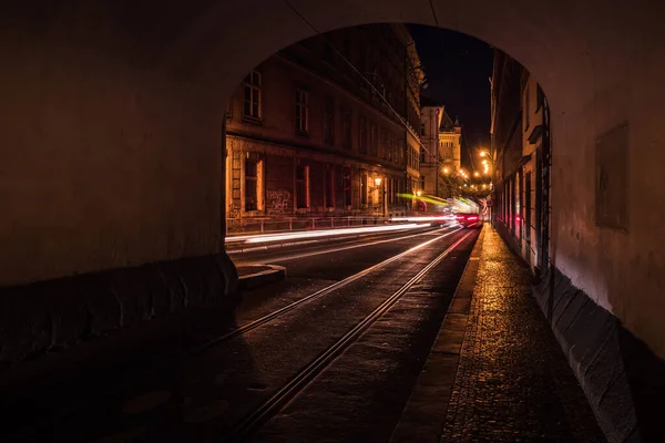 Smetanovo Nabrezi Passage in Prague at Night with Light Streaks and Reflections on the Cobblestones