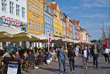 Kopenhag/Danimarka - 24 Ağustos 2018: Nyhavn Kopenhag, Danimarka waterfront semtinde olduğunu. İnsanlar burada yemek yemek emretmek için ve içme onların arkadaşları ve aile ile geliyor bu yüzden güneşli bir gün bugündür.
