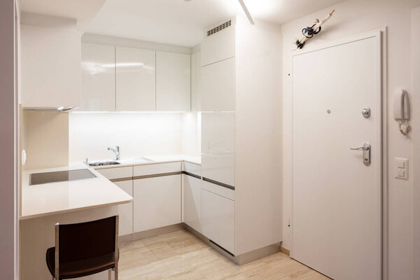 Design kitchen in modern apartment with stool. Nobody inside