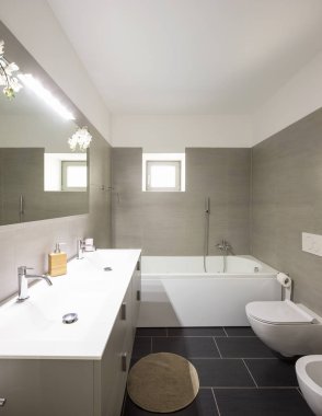 Modern banyo büyük kahverengi çini ve büyük ayna. İçeride kimse yok