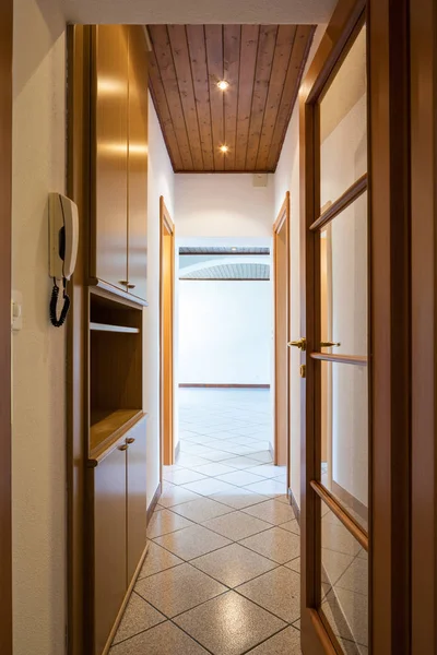 Corridor with wooden wardrobes and intercom in foreground. Nobody inside — Stock Image Corridor Wooden Wardrobes Intercom Foreground Nobody Royalty Free Stock Images