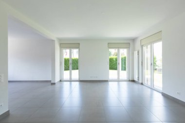 Boş oda pencere ve tamamen beyaz duvar ile. İçeride kimse yok