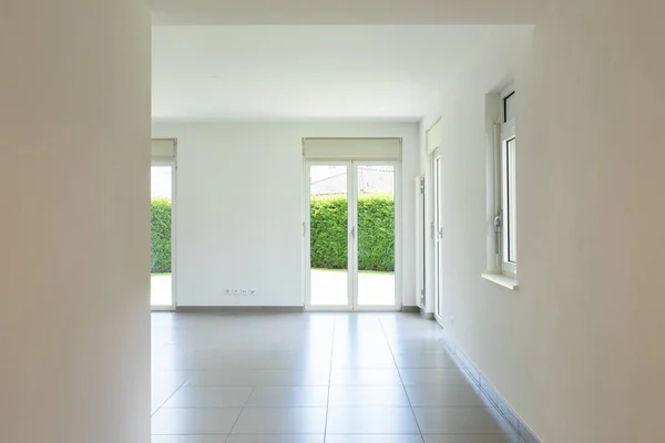 Empty room with window and totally white walls. Nobody inside