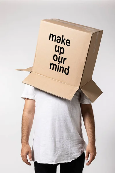 Man with box on his head, make uo our mind. Concept