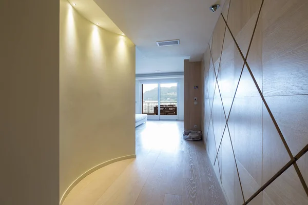 Elegant wooden corridor with spotlights in modern apartment. Nobody inside — Stock Image Elegant Wooden Corridor Spotlights Modern Apartment Nobody Royalty Free Stock Photos