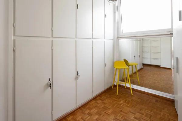 Room with white cabinets and a yellow stool. Nobody inside — Stock Image Room White Cabinets Yellow Stool Nobody Stock Picture