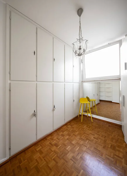 Room with white cabinets and a yellow stool. Nobody inside — Stock Image Room White Cabinets Yellow Stool Nobody Royalty Free Stock Images