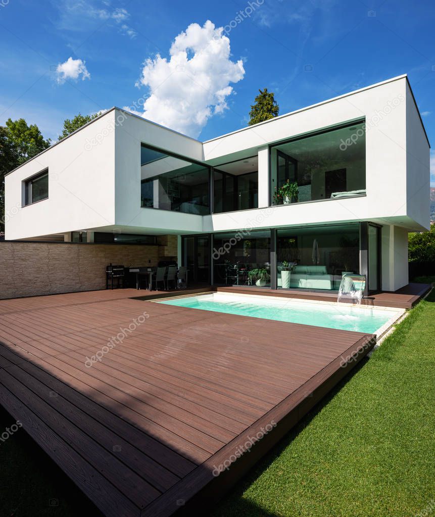 Exterior modern white villa with pool and garden, nobody inside