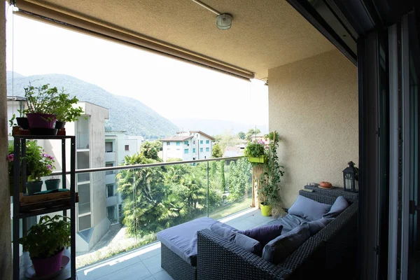 Terrace with outdoor furniture and seen on the Swiss hills