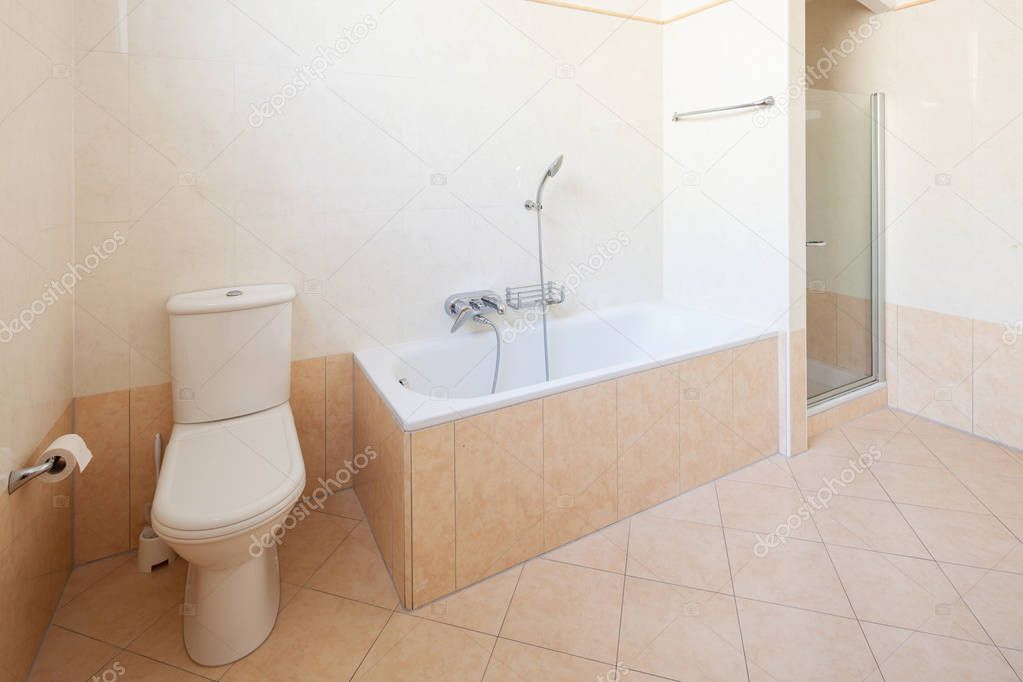 Bright bathroom with tiles, nobody inside