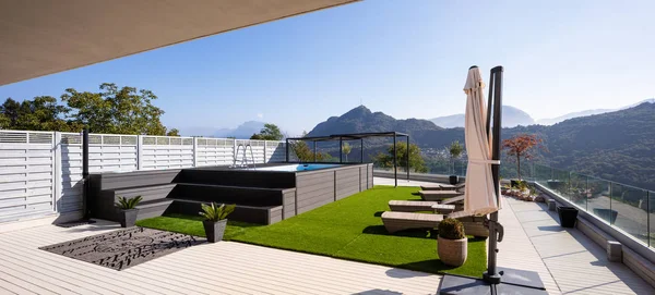 Giant balcony of modern apartment with swimming pool on a summer day. Nobody inside