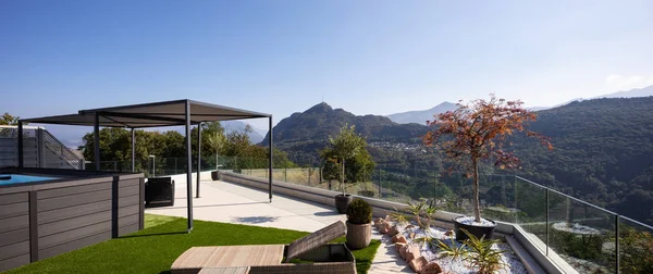 Giant balcony of modern apartment with swimming pool on a summer day. Nobody inside