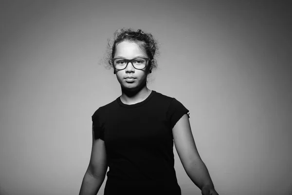 Portrait of teen with glasses in the studio. copy space