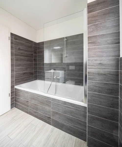 Bathroom with elegant minimalist brown tiles. Nobody inside