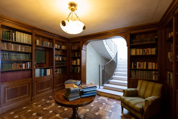 Private library in wood, classic style. Luxury. Marble stairs