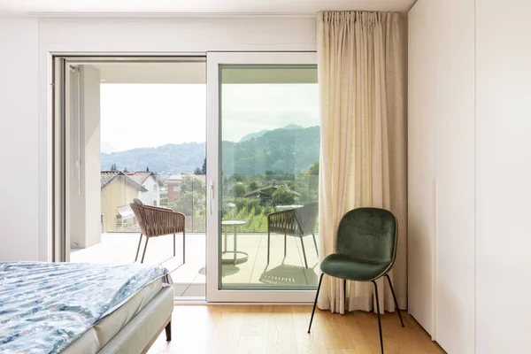 Modern bedroom with bed and velvet chair — Stock Photo, Image